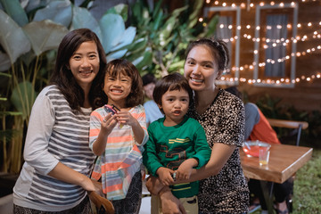 mother and children enjoy the party in backyard