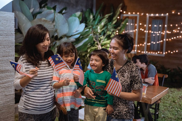 mother and children enjoy the party in backyard