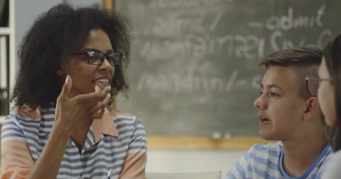 Teacher explaining to pupils in a classroom