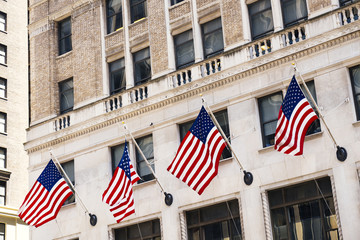 Stone building facade decorated with American flags