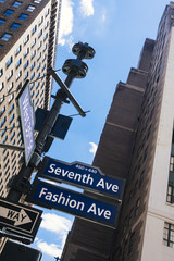 Fototapeta na wymiar Manhattan street signs and skyscrapers from below view
