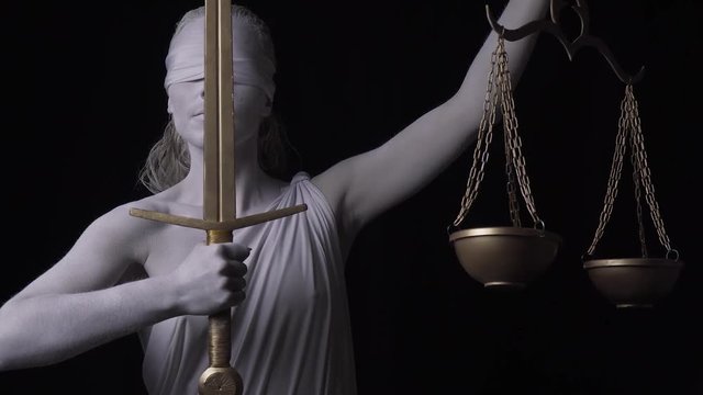 Marble human statue of Themis is holding up the golden sword and the scales, 4k