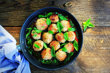 Meatballs in sweet and sour tomato sauce on rustic table. Top view