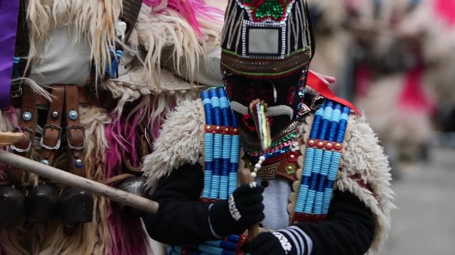 bulgarian kid kuker coming out and then in and then out of focus again with a beads costume
