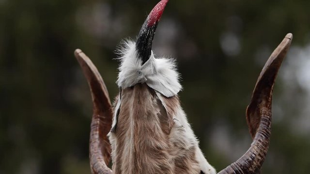 Bulgarian kuker wolf alike with horns mask and bloody eyes.