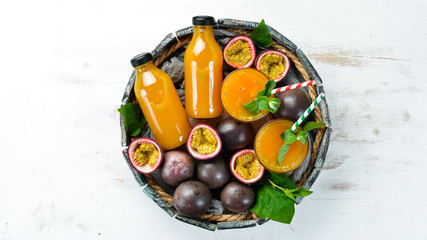 Passion fruits and juice on a white background. Tropical Fruits. Top view. Free space for text.