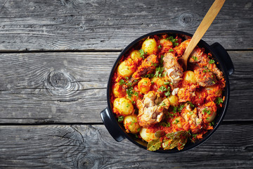 close-up of braised hake in a black pan