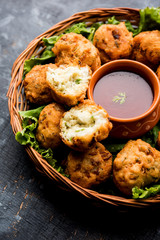 rava Bhajj or bhajiya also known as suji Pakoda or semolina Pakora, served with tomato ketchup. selective focus