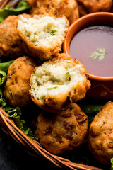 rava Bhajj or bhajiya also known as suji Pakoda or semolina Pakora, served with tomato ketchup. selective focus