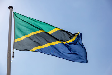 Tanzanian flag waving against clear blue sky