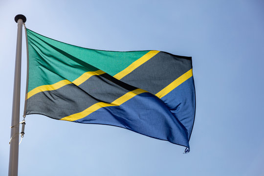 Tanzanian flag waving against clear blue sky