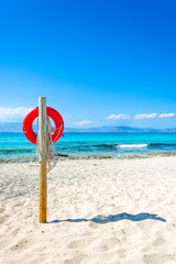 A lifebuoy, symbol of assistance, security, rescue, SOS on Golden Beach in Chrysi island, Crete, Greece.