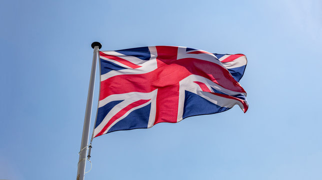 Great Britain flag waving against clear blue sky