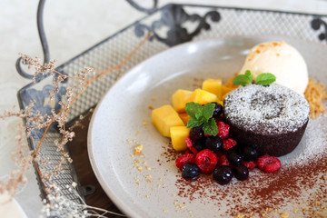 Delicious and beautiful dessert of .Chocolate cake with summer berries,mango.