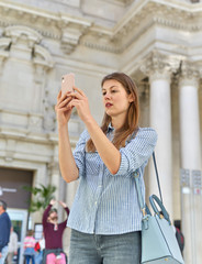 Fototapeta premium young beautiful girl considers exhibits in museum