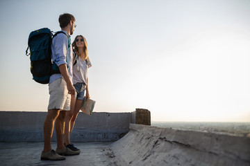 Happy couple on vacation sightseeing city with map