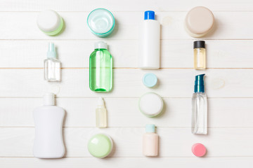 Group of plastic bodycare bottle Flat lay composition with cosmetic products on wooden background empty space for you design. Set of White Cosmetic containers, top view with copy space