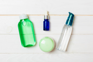 Cosmetics SPA branding mock-up, top view with copy space. set of tubes and jars of cream flat lay on white wooden background