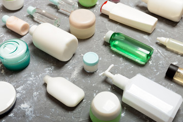 Group of plastic bodycare bottle Flat lay composition with cosmetic products on blue background empty space for you design. Set of White Cosmetic containers, top view with copy space