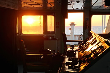 View of the sunset from the ship"s construction and navigational bridge. © masterskuz55