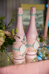 Wedding decoration. Pink bottles of champagne