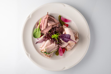 Slicing gourmet meat, pastrami, podcherevka, bastrum, beef and pork. Banquet festive dishes. Gourmet restaurant menu. White background.