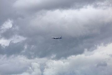 Big aircraft of russian airline Aeroflot flies in the sky in cloudy weather. Moscow, Russia
