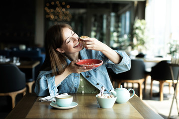 young girl drinking a tea with dessert