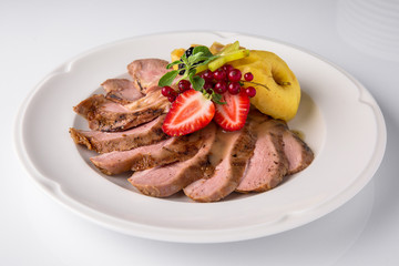Slicing gourmet meat, pastrami, podcherevka, bastrum, beef and pork. Banquet festive dishes. Gourmet restaurant menu. White background.