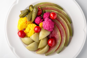 Homemade pickles: watermelon, tomatoes, cabbage, cucumbers, cauliflower. Banquet festive dishes. Gourmet restaurant menu. White background.