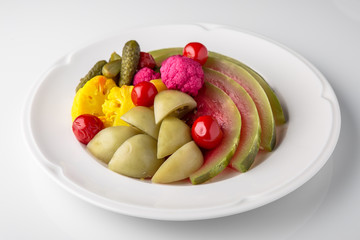 Homemade pickles: watermelon, tomatoes, cabbage, cucumbers, cauliflower. Banquet festive dishes. Gourmet restaurant menu. White background.