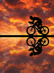 Silhouette  Cycling  on blurry sunrise  sky   background.