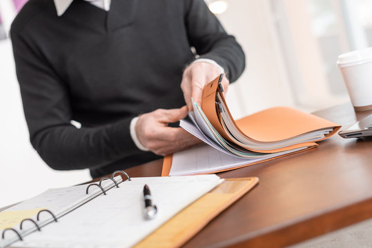 Businessman Looking For Document In Folder