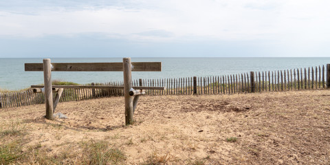 Rear view wood bench empty in Atlantic coast in Jard sur Mer Vendee France in web banner template banner