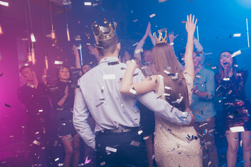 Back rear photo of charming lovers mates raise hand wear dress suit formalwear disco discotheque high-school event © deagreez