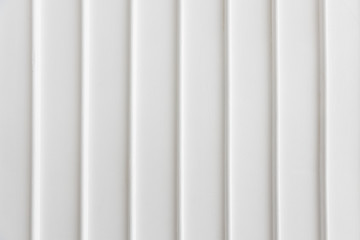 Fototapeta premium closeup of simplicity white wall with vertical line pattern panel background texture.