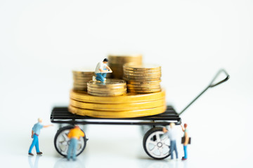 Miniature people: Investor on gold stack of coins with copy space using as background investment, exchange currency business concept.