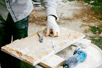 man works with a stone