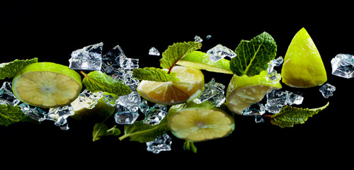 Mint, lime slices and ice on the glass table, bottom view.