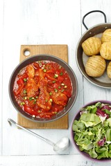 chicken drumsticks with pepper in tomato sauce