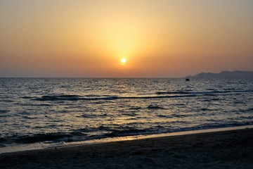 Sunset over Adriatic Sea. View from Golem / Durres, Albania. Beautiful sunset with Durres town silhouette in the distance