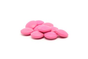 Obraz na płótnie Canvas Pink pills isolated on white background.