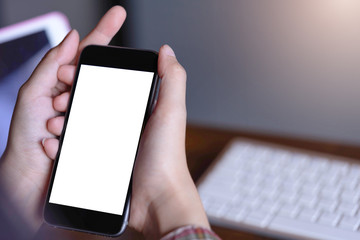 Woman’s hands holding smartphone with blank white screen can be add your texts or others, empty copy space for advertising, product display.