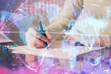 International business hologram over woman's hands taking notes background. Concept of success....