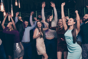 Nice attractive adorable fascinating cheerful cheery positive glad smart elegant chic stylish trendy ladies and gentlemen having fun festive in fashionable luxurious nightclub indoors