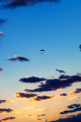 skydiver against the sunset sky