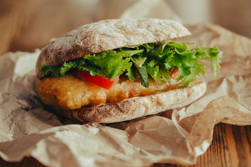 fried fish Sandwich with lettuce, tomato with tartar sauce. author's recipe street food