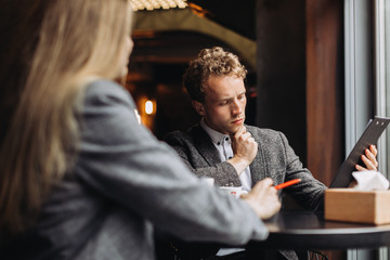 Young businessmen having a meeting in a cafe
