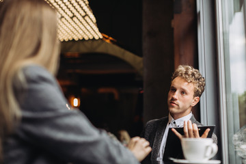 Young businessmen having a meeting in a cafe