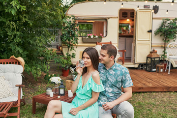 Lovers near house on wheels on picnic. Family vacation travel RV,holiday trip in motorhome.Caravan car Vacation. Caravan car, holiday trip.Trailer motor home. Leisure mobile camping. Summer holiday